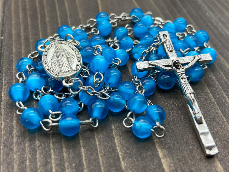 [Australia] - Nazareth Store Rosary Necklace 7mm Round Light Blue Beads Turquoise Cat Eye Stone Miraculous Medal with Crucifix - Velvet Bag 